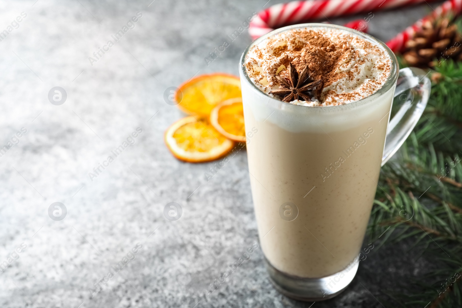 Delicious Christmas cocktail with liqueur on grey table. Space for text Photo of Delicious Christmas cocktail with liqueur on grey table. Space for text