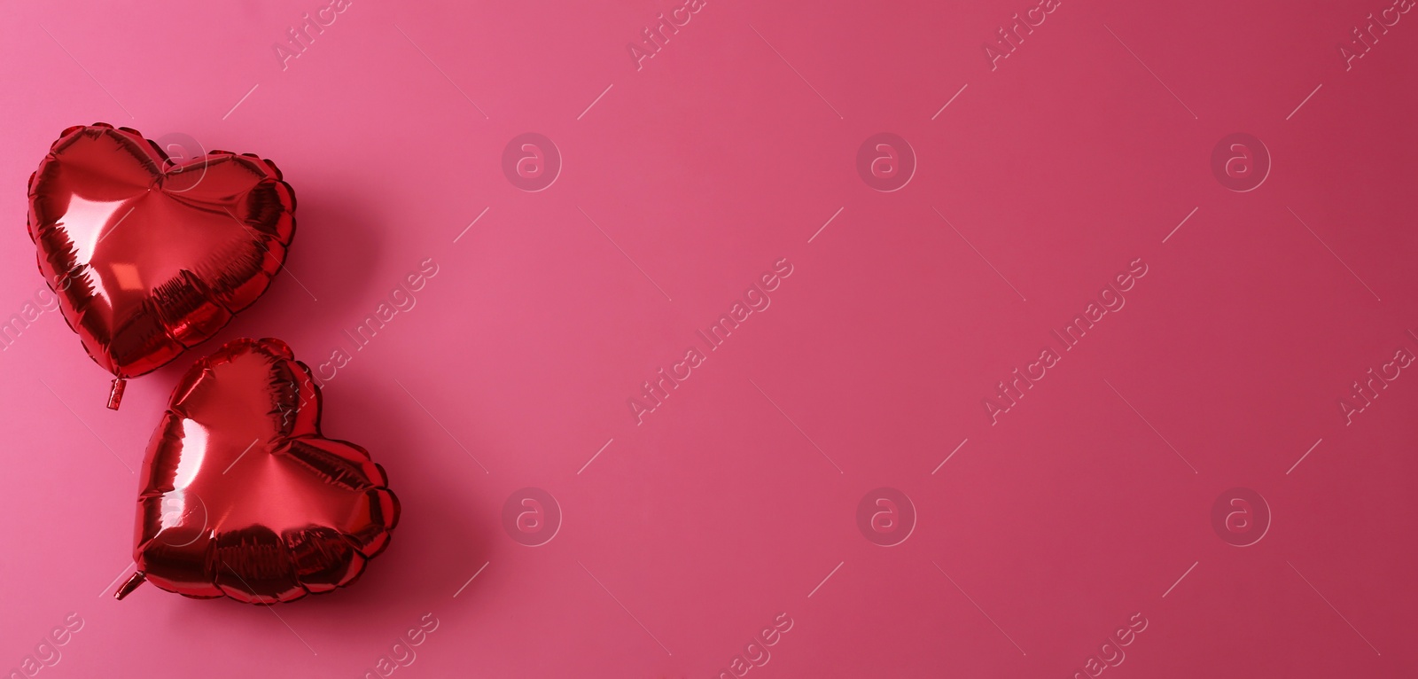 Red heart shaped balloons on pink background, flat lay with space for text. Saint Valentine's day celebration Photo of Red heart shaped balloons on pink background, flat lay with space for text. Saint Valentine's day celebration