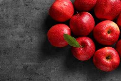 Fresh red apples with drops of water on grey background Photo of Fresh red apples with drops of water on grey background