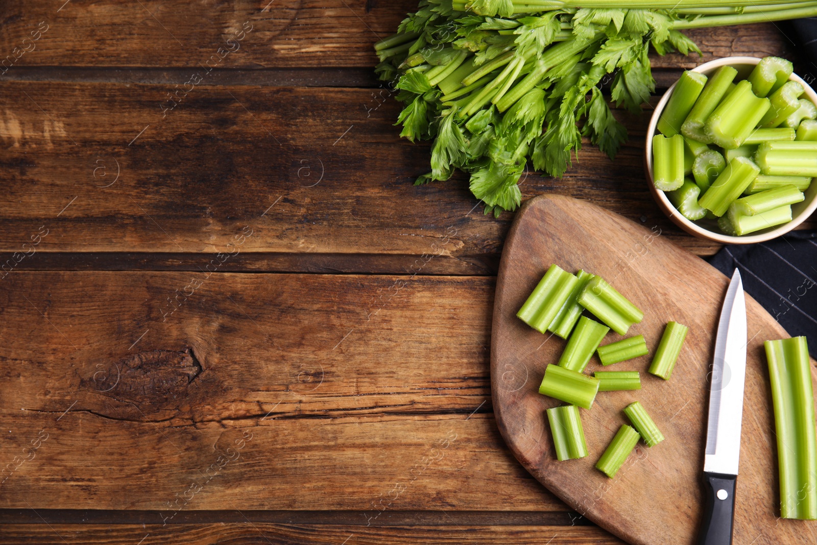 Fresh ripe green celery on wooden table, flat lay. Space for text Photo of Fresh ripe green celery on wooden table, flat lay. Space for text
