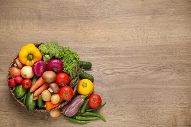 Different fresh vegetables on wooden table, flat lay. Space for text Photo of Different fresh vegetables on wooden table, flat lay. Space for text