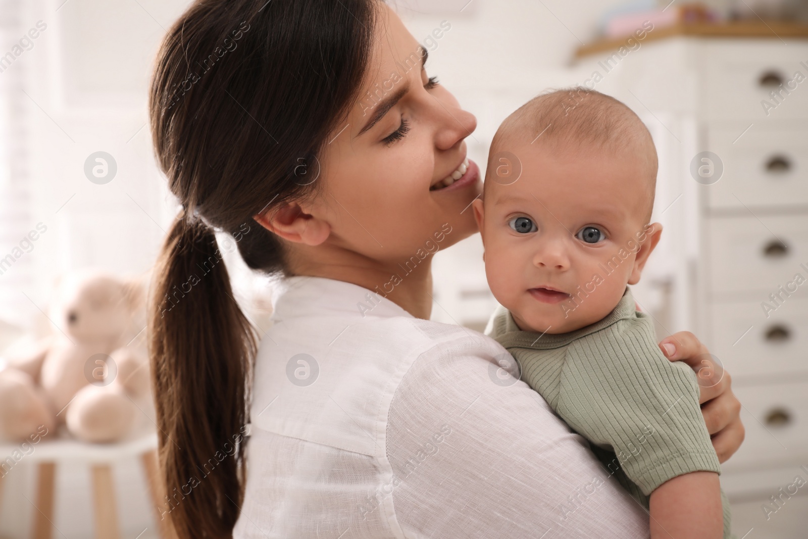 Happy young mother with her cute baby at home Photo of Happy young mother with her cute baby at home