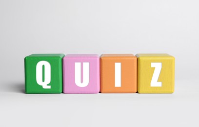 Colorful cubes with word Quiz on white background Photo of Colorful cubes with word Quiz on white background
