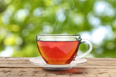 Cup of hot freshly brewed rooibos tea on wooden table outdoors Image of Cup of hot freshly brewed rooibos tea on wooden table outdoors