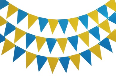 Buntings with colorful triangular paper flags on white background. Festive decor Photo of Buntings with colorful triangular paper flags on white background. Festive decor