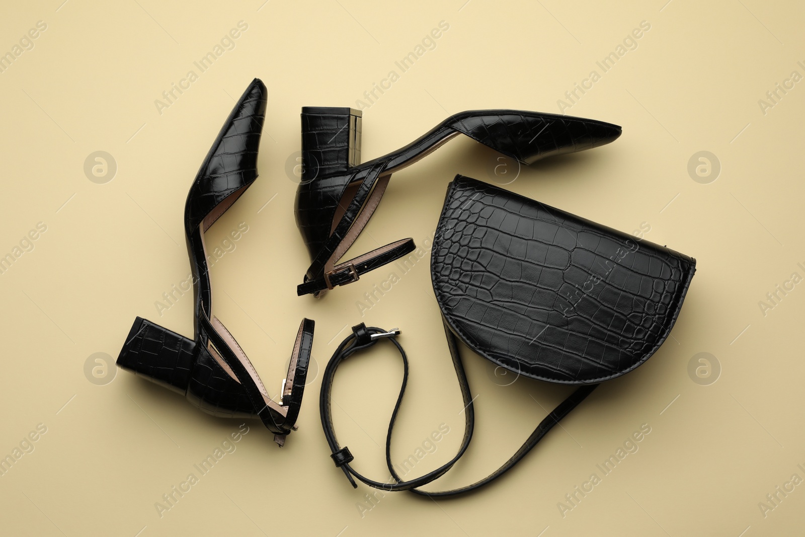 Stylish woman's bag on beige background, flat lay Photo of Stylish woman's bag on beige background, flat lay