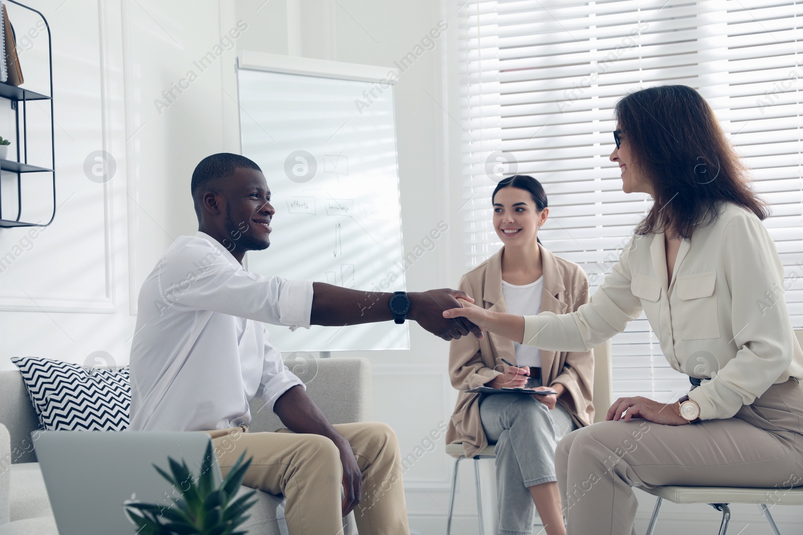 Boss shaking hands with new coworker during job interview in office Photo of Boss shaking hands with new coworker during job interview in office