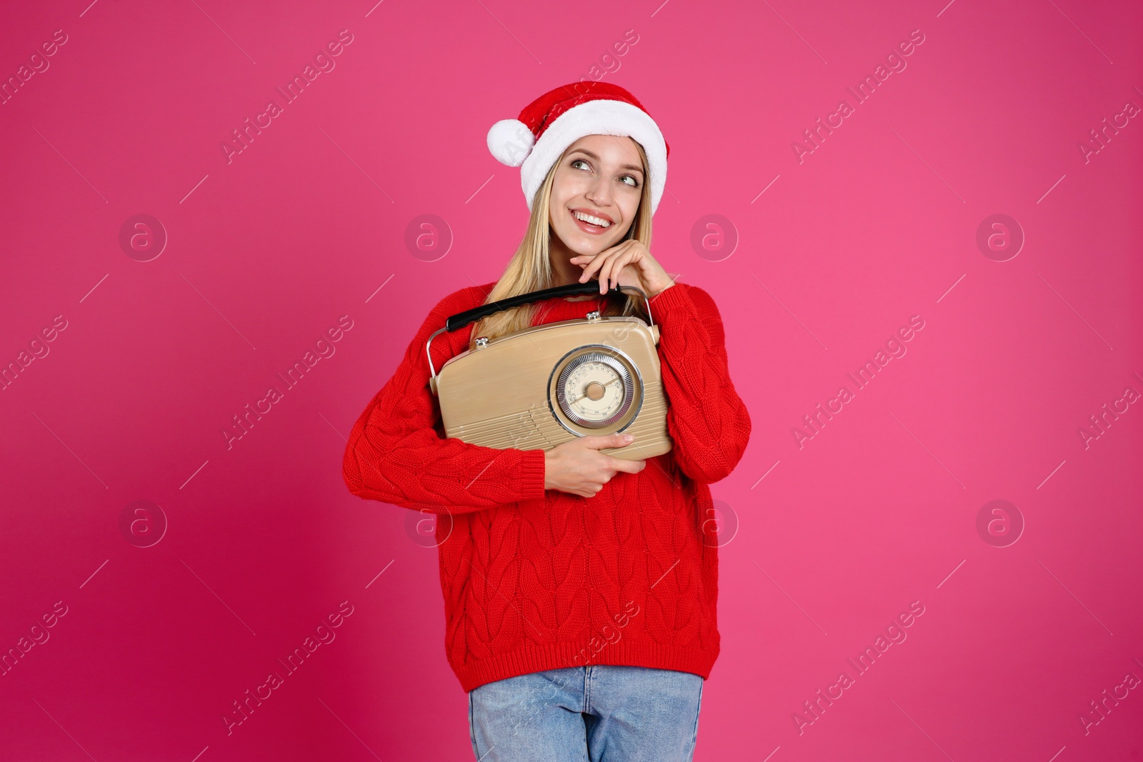 Photo of Happy woman with vintage radio on pink background. Christmas music