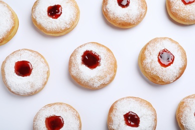 Hanukkah doughnuts with jelly and sugar powder on white background, top view Photo of Hanukkah doughnuts with jelly and sugar powder on white background, top view