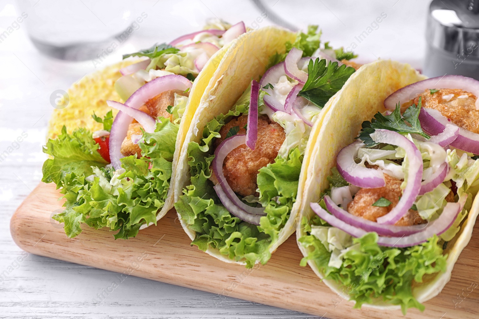 Yummy fish tacos served on white wooden table, closeup Photo of Yummy fish tacos served on white wooden table, closeup
