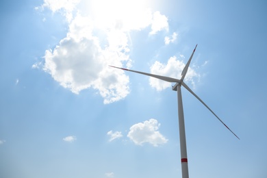 Modern wind turbine against blue sky, low angle view. Energy efficiency Photo of Modern wind turbine against blue sky, low angle view. Energy efficiency