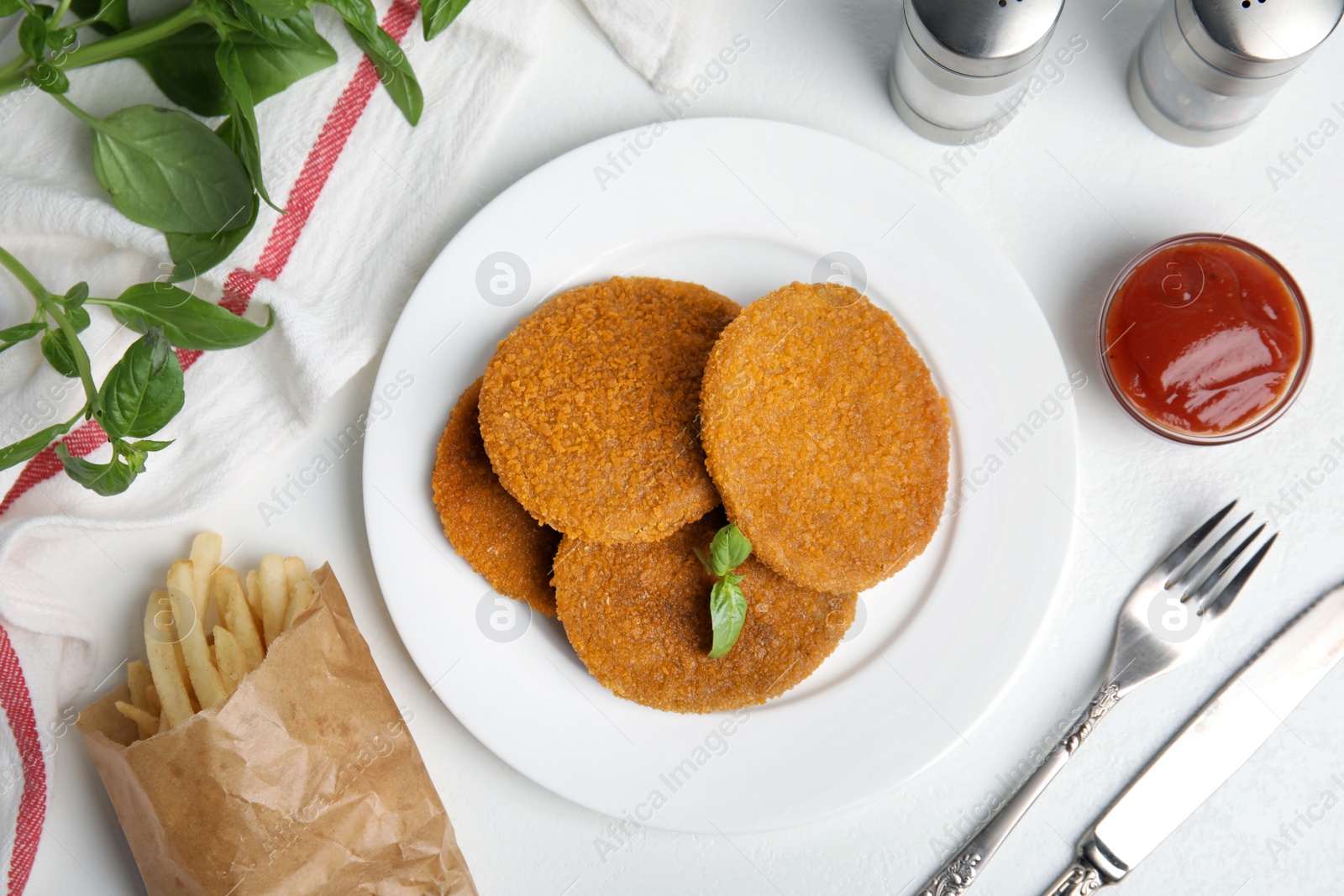 Delicious fried breaded cutlets served on white table, flat lay Photo of Delicious fried breaded cutlets served on white table, flat lay