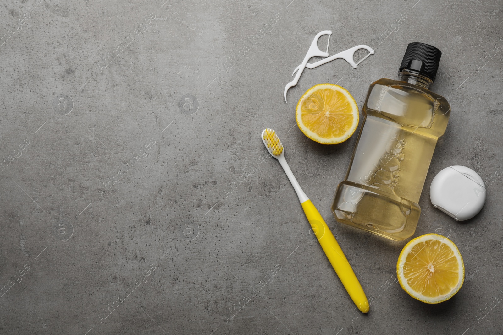 Flat lay composition with mouthwash and other oral hygiene products on grey table. Space for text Photo of Flat lay composition with mouthwash and other oral hygiene products on grey table. Space for text
