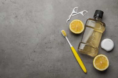 Flat lay composition with mouthwash and other oral hygiene products on grey table. Space for text Photo of Flat lay composition with mouthwash and other oral hygiene products on grey table. Space for text