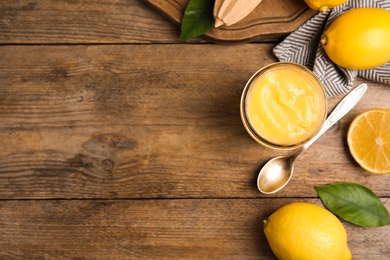 Delicious lemon curd and fresh fruits on wooden table, flat lay. Space for text Photo of Delicious lemon curd and fresh fruits on wooden table, flat lay. Space for text