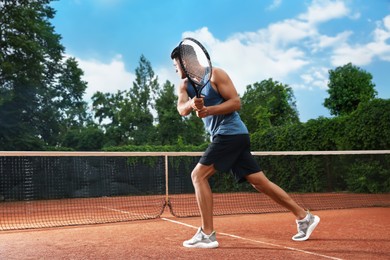 Man playing tennis on court. Racket sport Photo of Man playing tennis on court. Racket sport