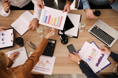 Businesspeople having meeting in office, top view. Management consulting Photo of Businesspeople having meeting in office, top view. Management consulting