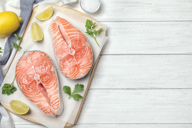Flat lay composition with fresh raw salmon on white wooden table, space for text. Fish delicacy Photo of Flat lay composition with fresh raw salmon on white wooden table, space for text. Fish delicacy