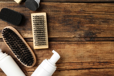 Flat lay composition with shoe care accessories on wooden background, space for text Photo of Flat lay composition with shoe care accessories on wooden background, space for text