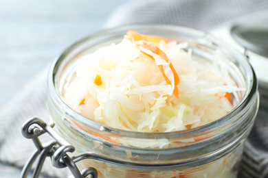 Jar with tasty homemade fermented cabbage, closeup Photo of Jar with tasty homemade fermented cabbage, closeup