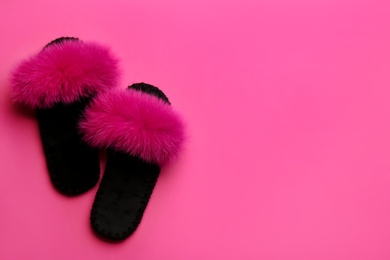 Pair of soft slippers on pink background, flat lay. Space for text Photo of Pair of soft slippers on pink background, flat lay. Space for text