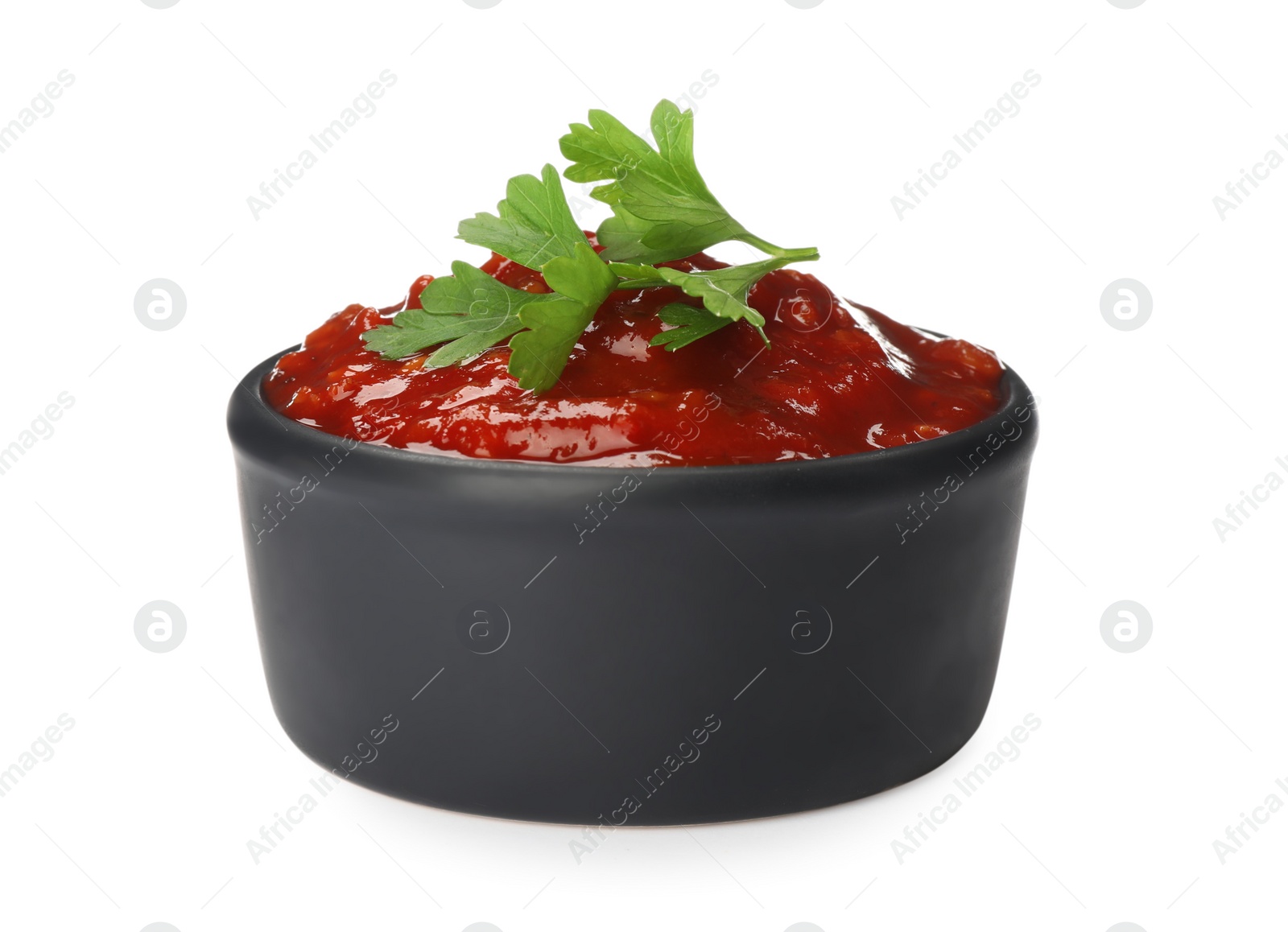 Delicious adjika sauce and parsley in bowl isolated on white Photo of Delicious adjika sauce and parsley in bowl isolated on white