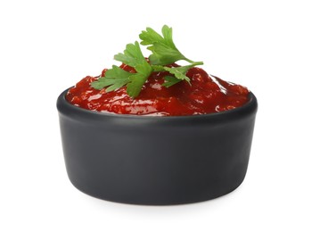 Delicious adjika sauce and parsley in bowl isolated on white Photo of Delicious adjika sauce and parsley in bowl isolated on white