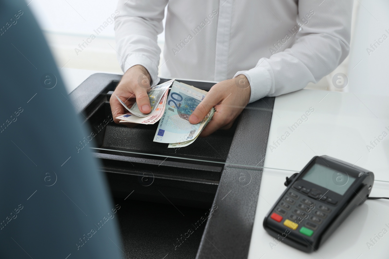 Cashier with money at bank, closeup. Currency exchange Photo of Cashier with money at bank, closeup. Currency exchange
