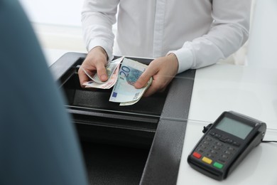 Cashier with money at bank, closeup. Currency exchange Photo of Cashier with money at bank, closeup. Currency exchange