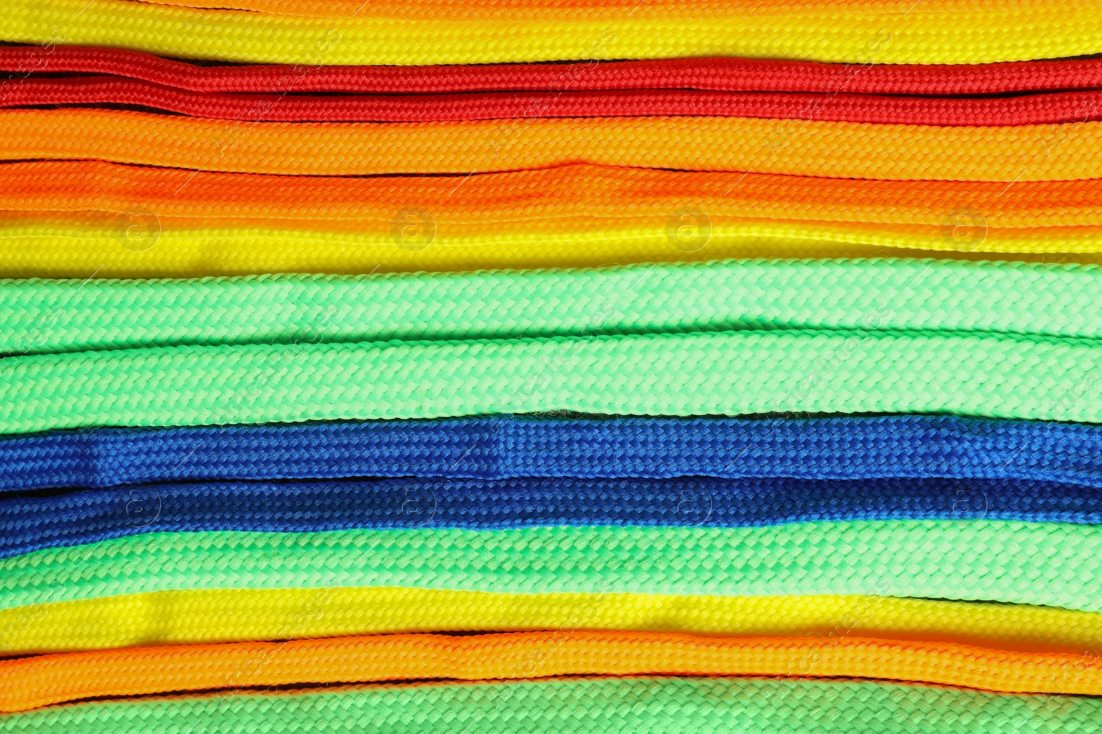 Colorful shoelaces as background, closeup. Stylish accessory Photo of Colorful shoelaces as background, closeup. Stylish accessory