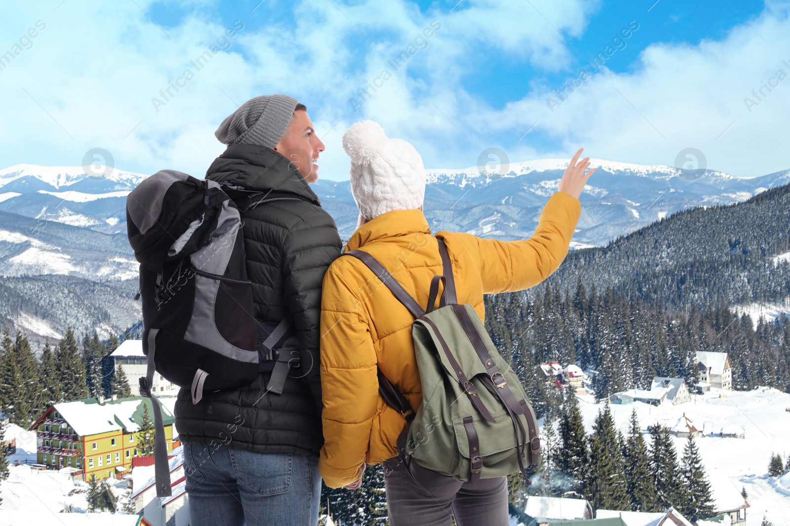 Happy couple with travel backpacks enjoying mountain landscape during vacation trip Image of Happy couple with travel backpacks enjoying mountain landscape during vacation trip