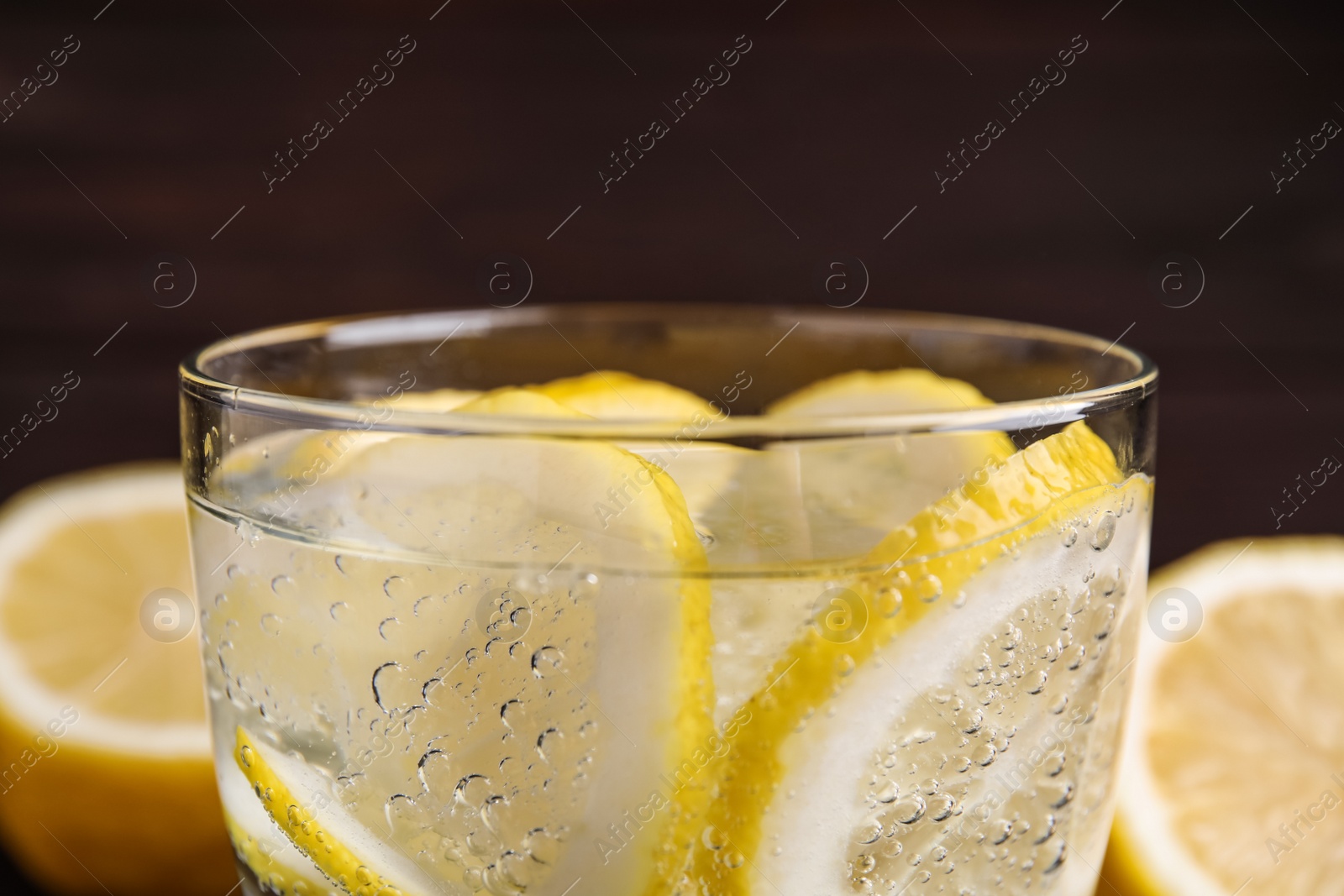 Soda water with lemon slices on dark background, closeup Photo of Soda water with lemon slices on dark background, closeup