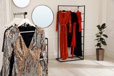 Collection of trendy women's garments on rack in clothing rental salon, space for text Photo of Collection of trendy women's garments on rack in clothing rental salon, space for text