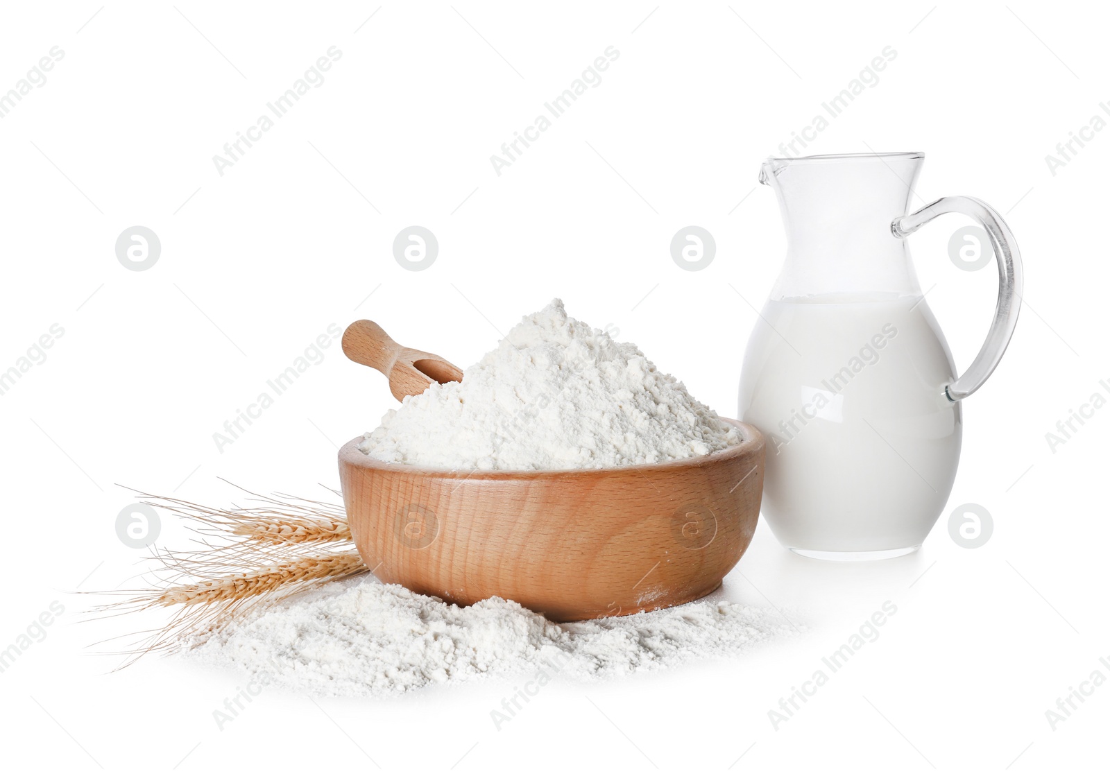 Wheat flour and jug of milk on white background Photo of Wheat flour and jug of milk on white background