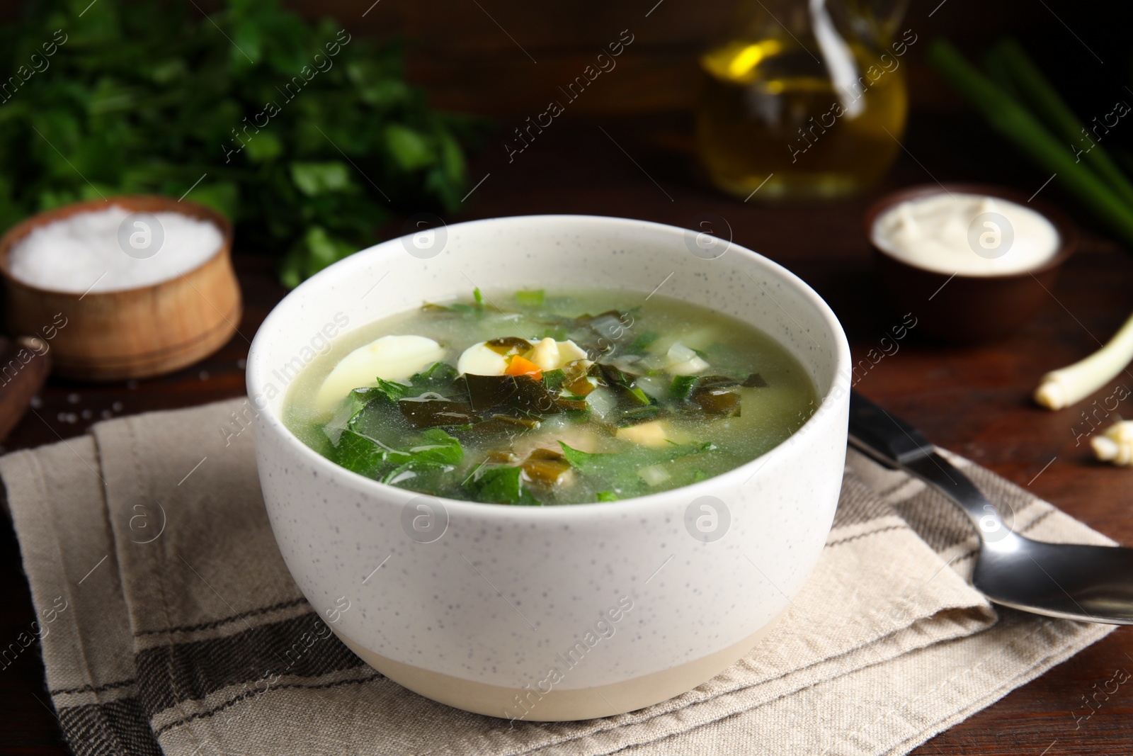 Delicious sorrel soup served on wooden table Photo of Delicious sorrel soup served on wooden table