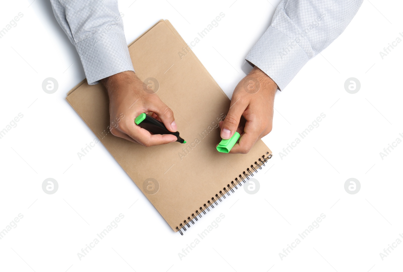 Man with highlighter and notepad on white background, top view. Closeup of hands Photo of Man with highlighter and notepad on white background, top view. Closeup of hands