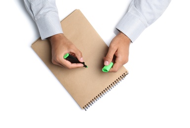 Man with highlighter and notepad on white background, top view. Closeup of hands Photo of Man with highlighter and notepad on white background, top view. Closeup of hands