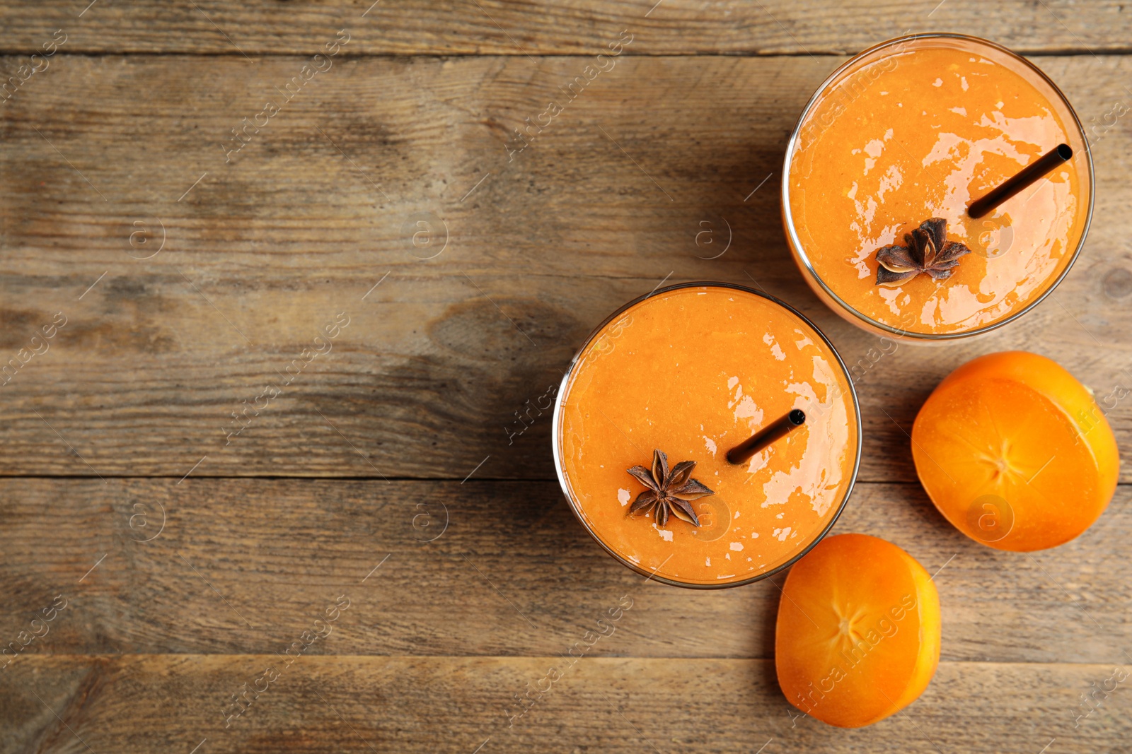 Tasty persimmon smoothie with anise and fresh fruits on wooden table, flat lay. Space for text Photo of Tasty persimmon smoothie with anise and fresh fruits on wooden table, flat lay. Space for text