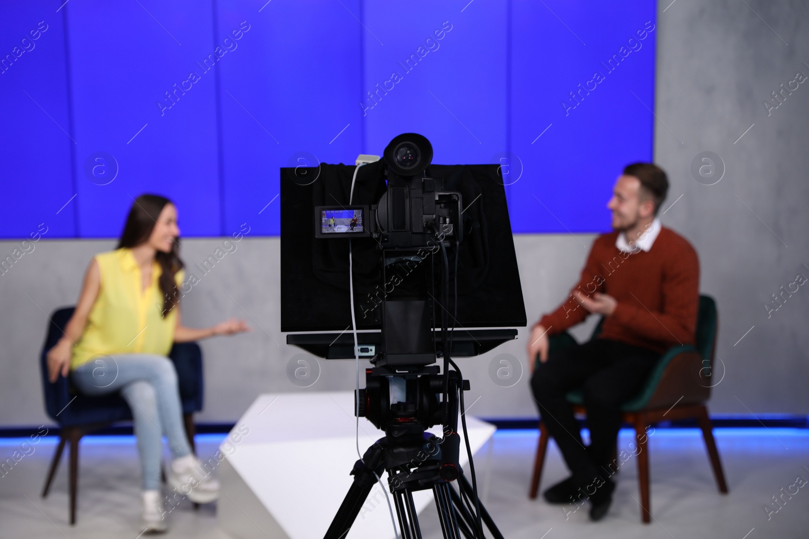 Presenters working in studio, focus on video camera Photo of Presenters working in studio, focus on video camera