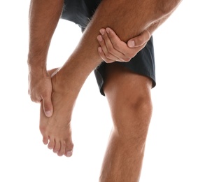 Man suffering from foot pain on white background, closeup Photo of Man suffering from foot pain on white background, closeup