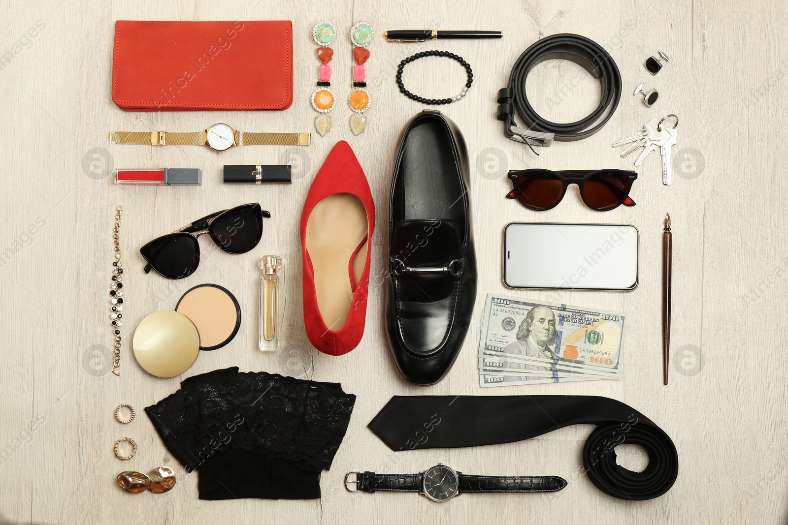 Fashionable male and female accessories on wooden background, flat lay Photo of Fashionable male and female accessories on wooden background, flat lay