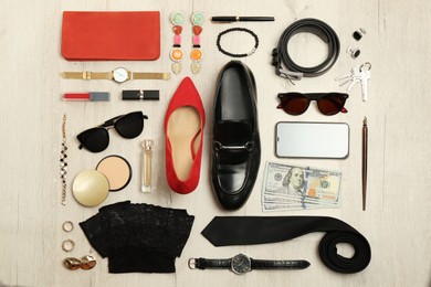 Fashionable male and female accessories on wooden background, flat lay Photo of Fashionable male and female accessories on wooden background, flat lay
