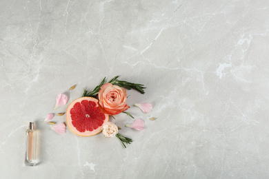Flat lay composition with bottle of perfume on marble background, space for text Photo of Flat lay composition with bottle of perfume on marble background, space for text