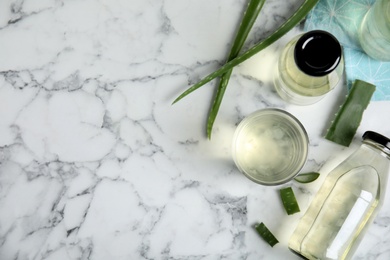 Fresh aloe drink and leaves on white marble table, flat lay. Space for text Photo of Fresh aloe drink and leaves on white marble table, flat lay. Space for text