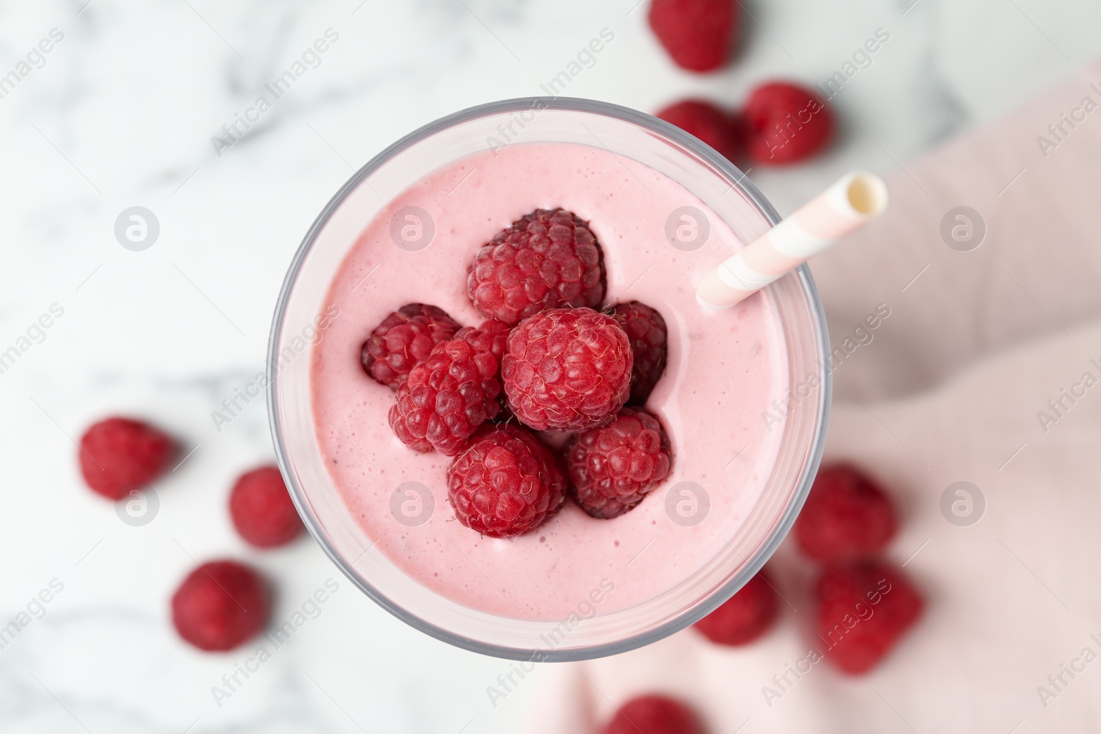 Yummy raspberry smoothie in glass on white marble table, top view Image of Yummy raspberry smoothie in glass on white marble table, top view