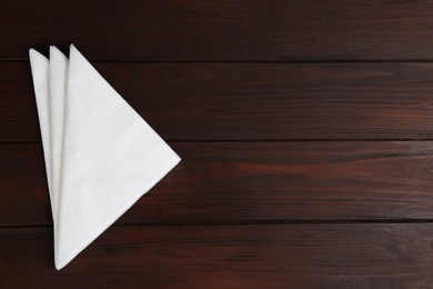 Clean napkins on wooden table, top view. Space for text Photo of Clean napkins on wooden table, top view. Space for text