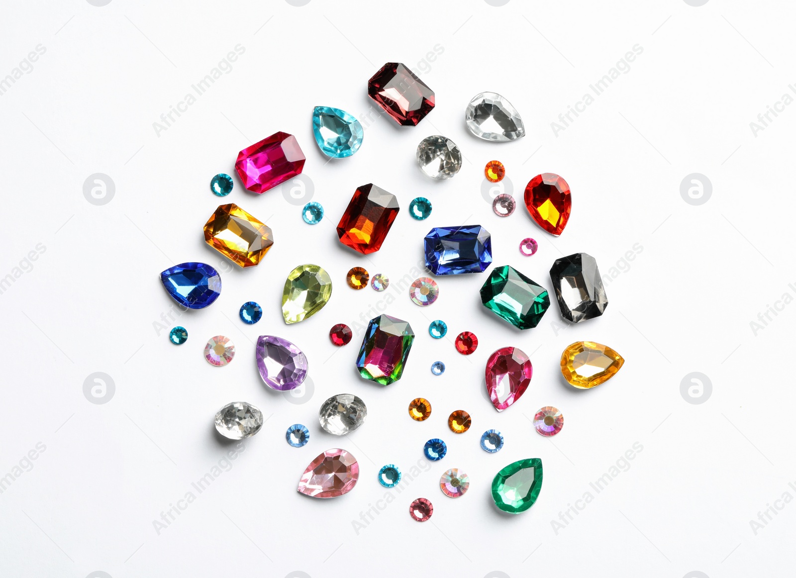 Different beautiful gemstones on white background, top view Image of Different beautiful gemstones on white background, top view