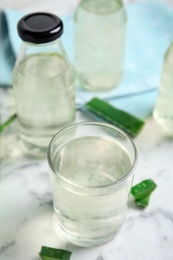 Fresh aloe drink on white marble table Photo of Fresh aloe drink on white marble table