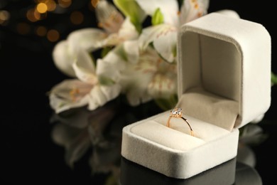Beautiful engagement ring in box against blurred background, space for text Photo of Beautiful engagement ring in box against blurred background, space for text