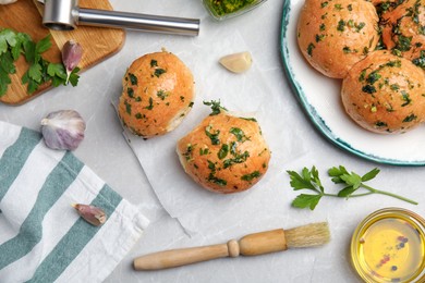 Traditional Ukrainian bread (Pampushky) with garlic on light grey marble table, flat lay Photo of Traditional Ukrainian bread (Pampushky) with garlic on light grey marble table, flat lay